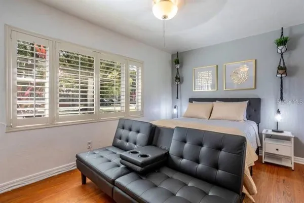 a bedroom with furniture and a window