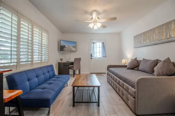 a living room with furniture and a chandelier
