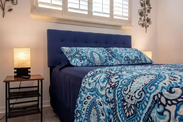 a bedroom with a large bed and a window