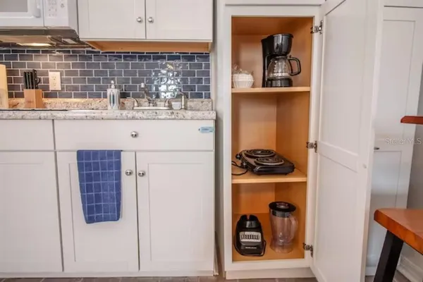 a kitchen with a stove and a refrigerator