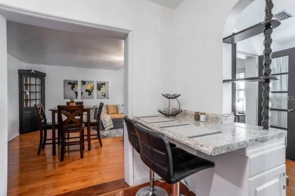 a view of a dining room with furniture and wooden floor