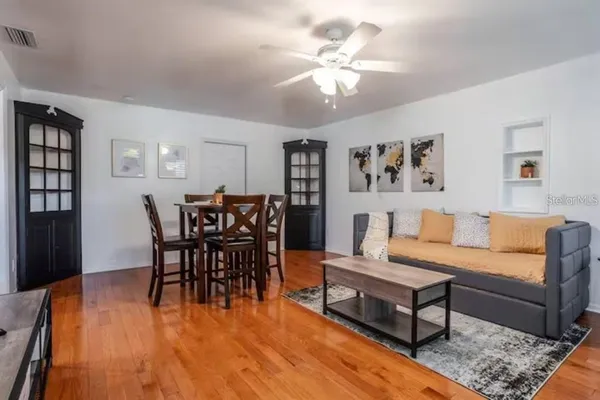 a living room with furniture and wooden floor