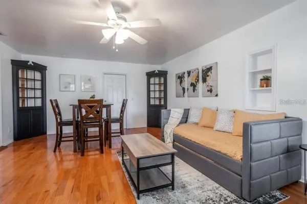 a living room with furniture and wooden floor