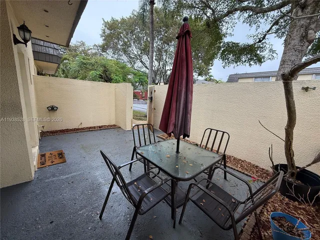 a view of a chairs and table in patio