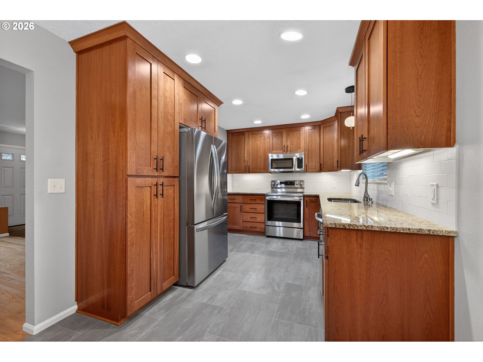 7450 Southwest 101st Avenue Beaverton, OR 97008 - Photo 12 of 37 a kitchen with stainless steel appliances granite countertop a refrigerator a sink and a stove
