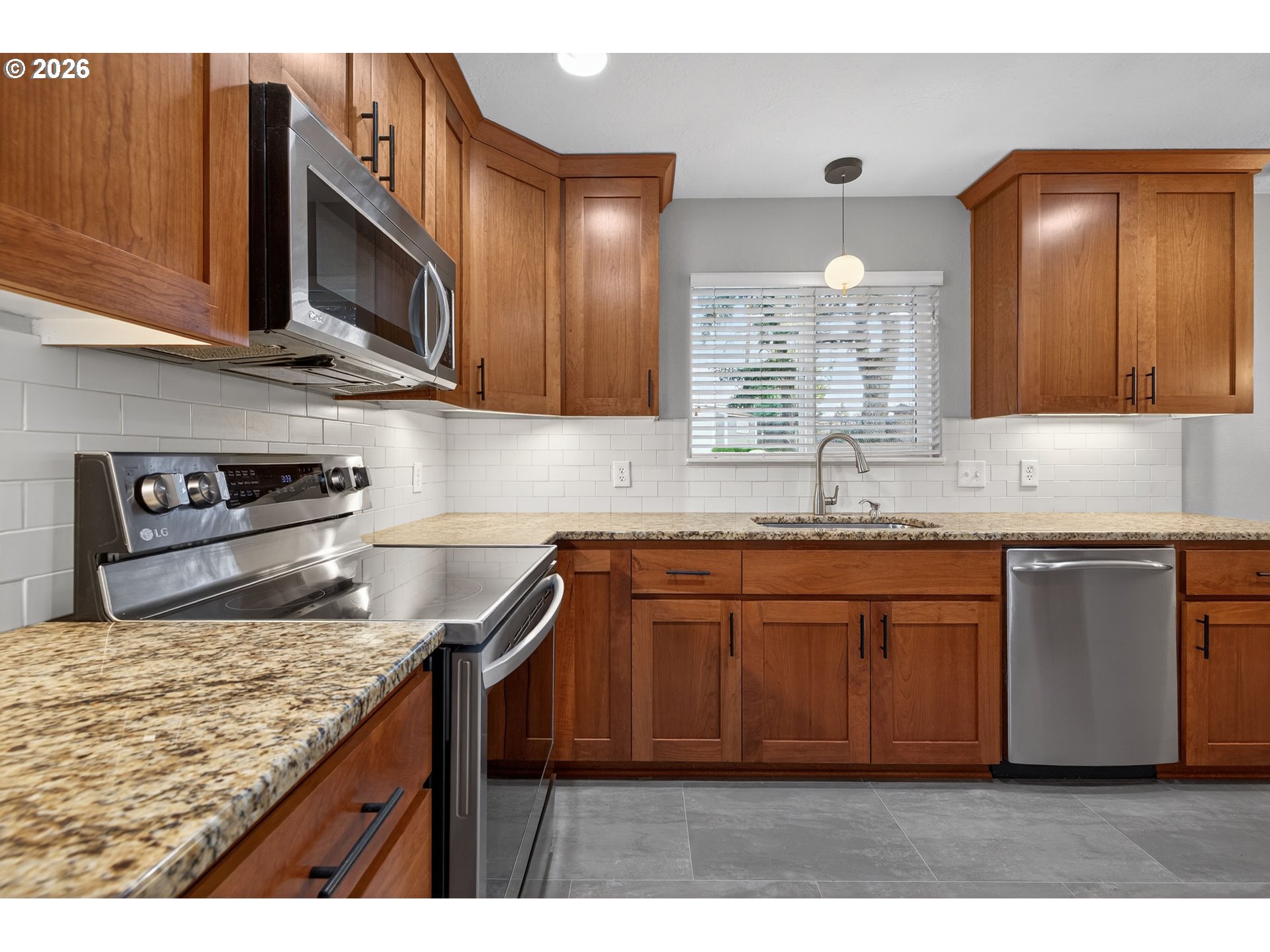 7450 Southwest 101st Avenue Beaverton, OR 97008 - Photo 13 of 37 a kitchen with stainless steel appliances granite countertop a sink stove and cabinets