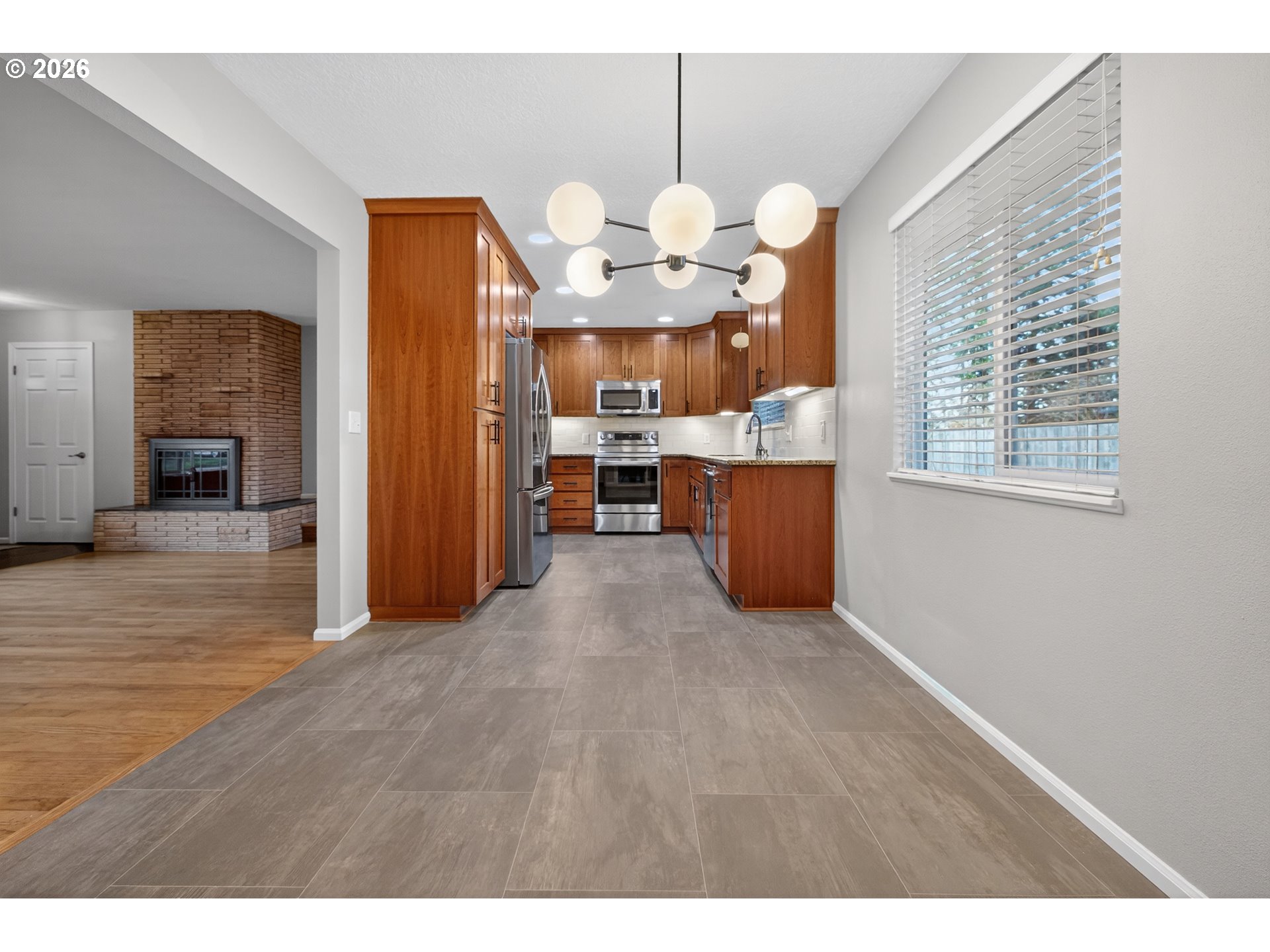 7450 Southwest 101st Avenue Beaverton, OR 97008 - Photo 15 of 37 a view of kitchen and dining room with wooden floor