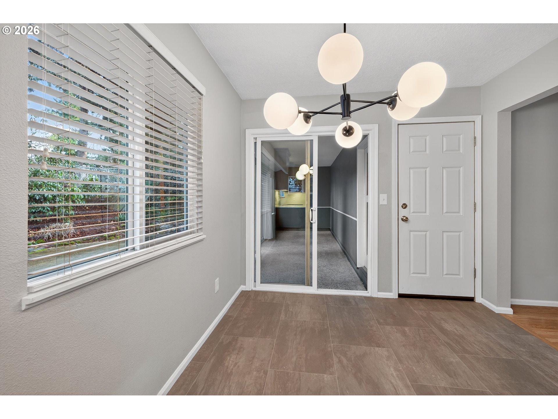 7450 Southwest 101st Avenue Beaverton, OR 97008 - Photo 16 of 37 a view of an empty room with a window and wooden floor