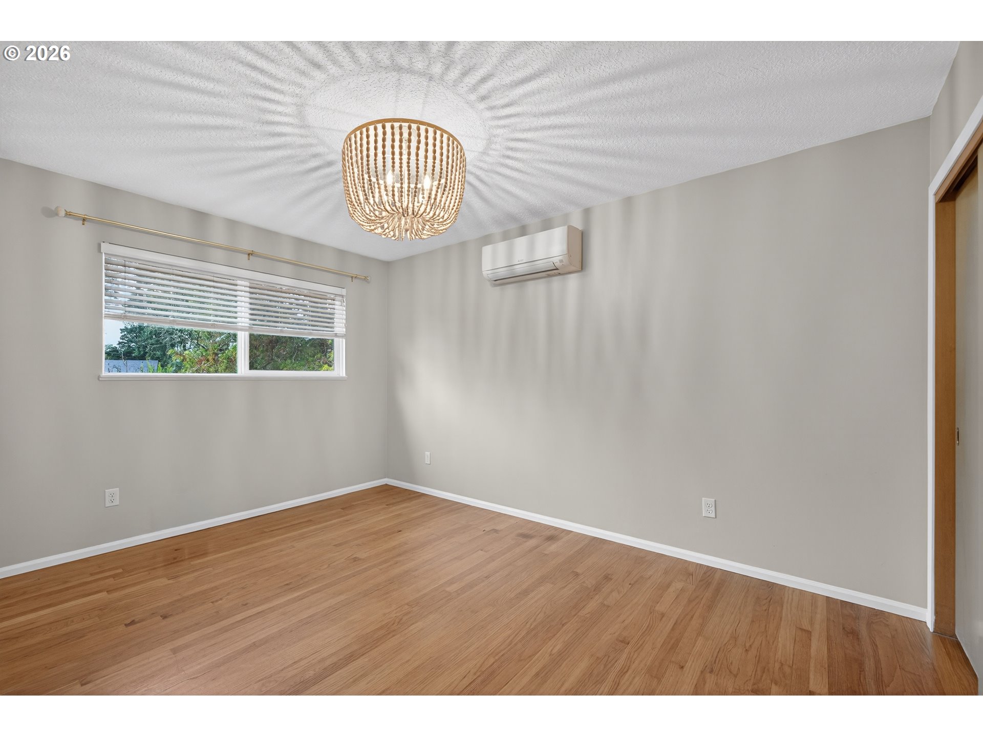 7450 Southwest 101st Avenue Beaverton, OR 97008 - Photo 20 of 37 a view of an empty room with wooden floor and a window