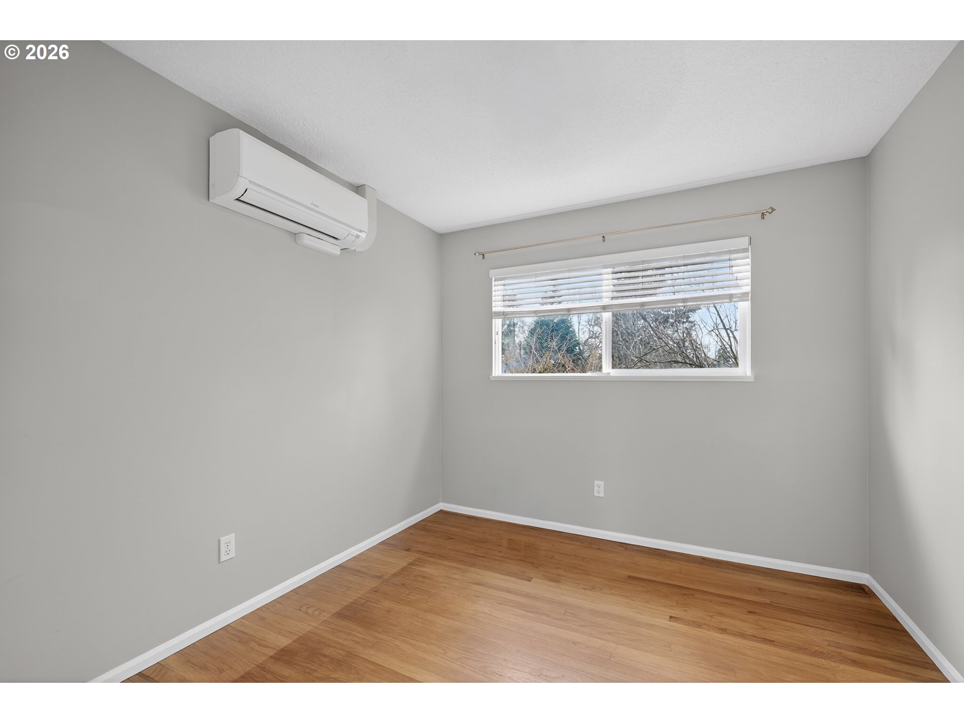 7450 Southwest 101st Avenue Beaverton, OR 97008 - Photo 21 of 37 a view of an empty room with wooden floor and a window