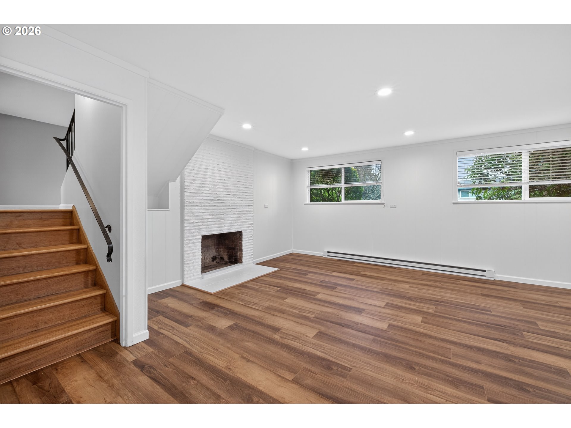 7450 Southwest 101st Avenue Beaverton, OR 97008 - Photo 24 of 37 a view of empty room with wooden floor and fireplace