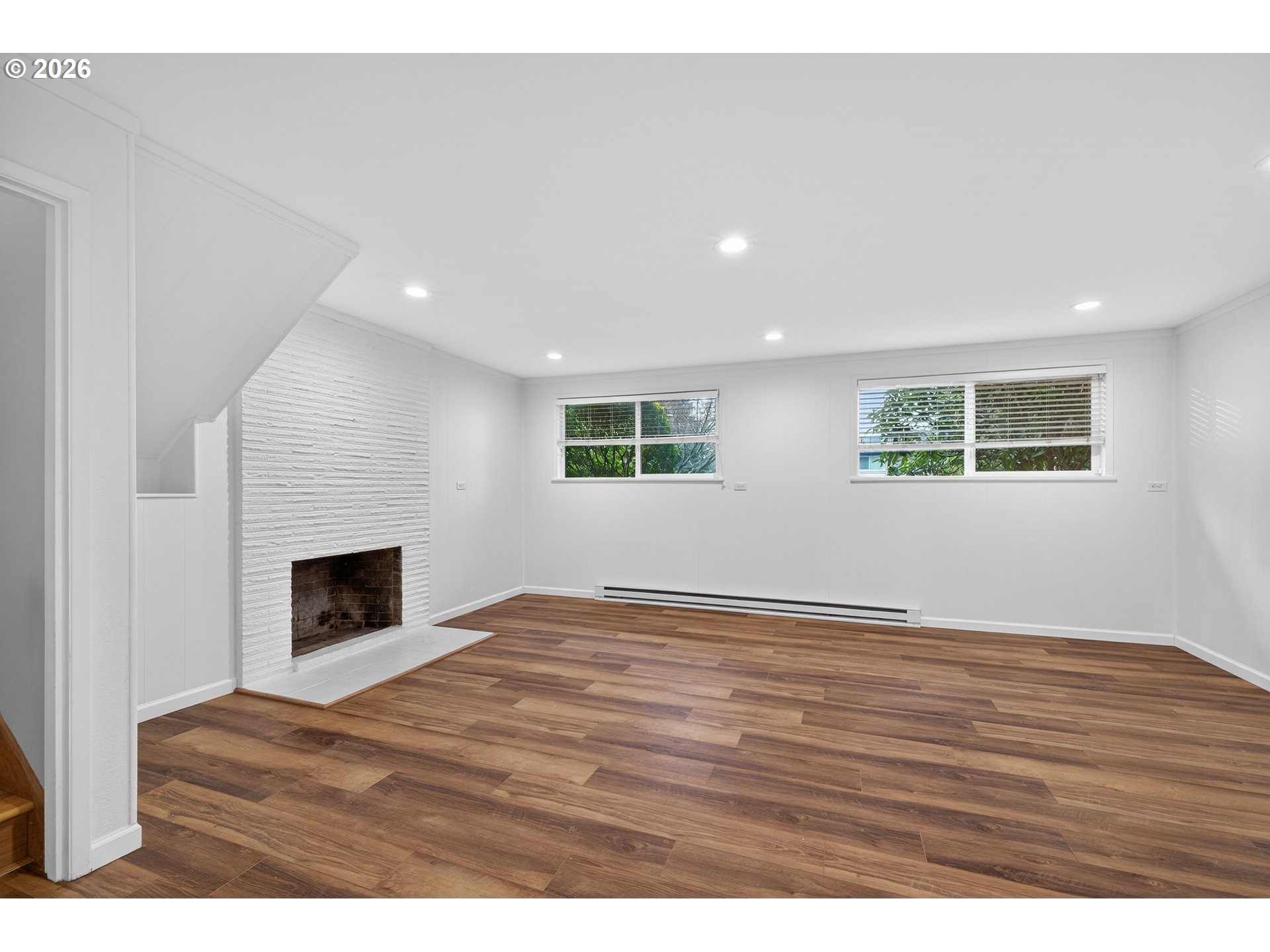 7450 Southwest 101st Avenue Beaverton, OR 97008 - Photo 27 of 37 a view of an empty room with wooden floor fireplace and a window