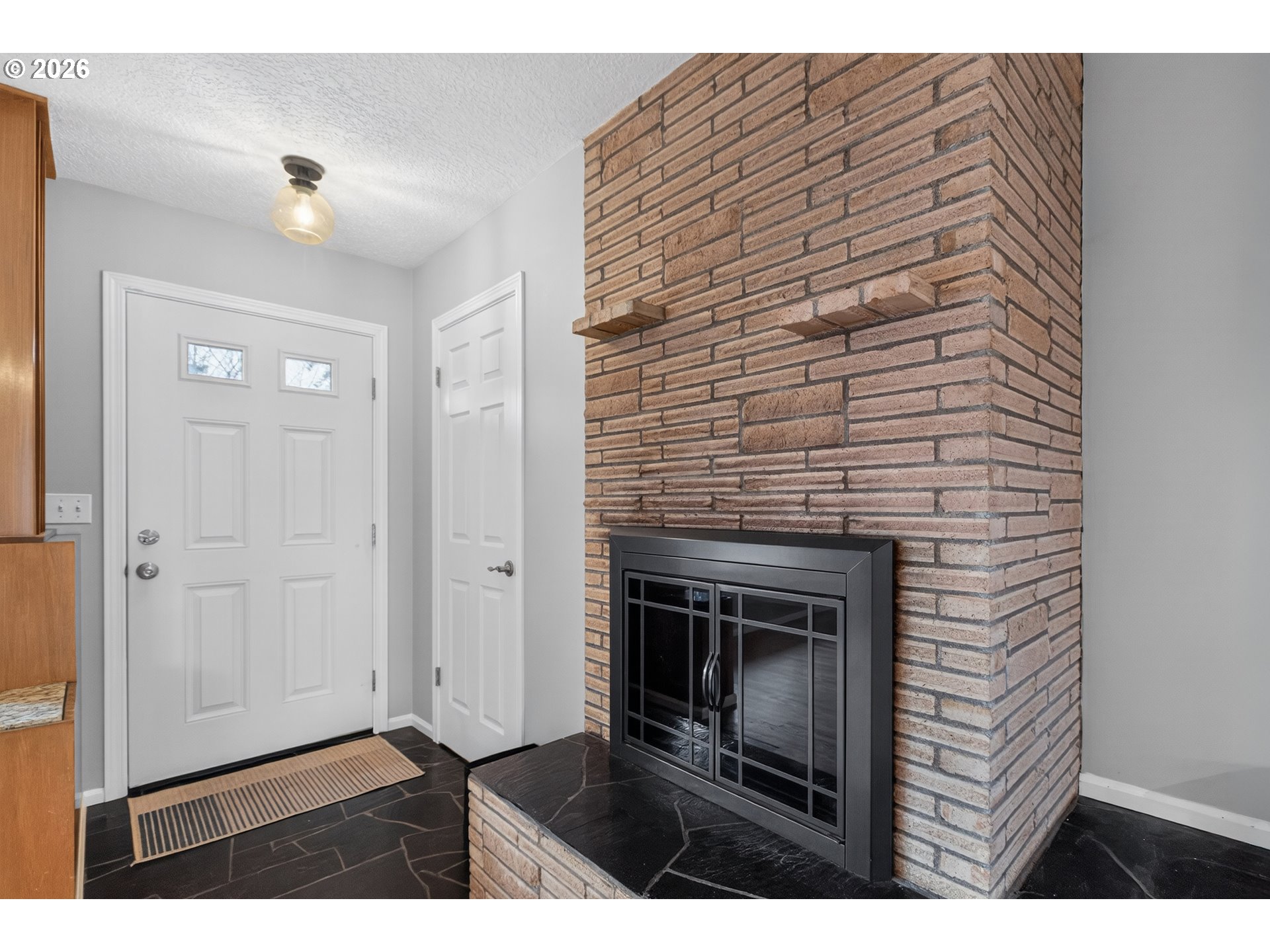 7450 Southwest 101st Avenue Beaverton, OR 97008 - Photo 4 of 37 a bedroom with a chair and a fireplace