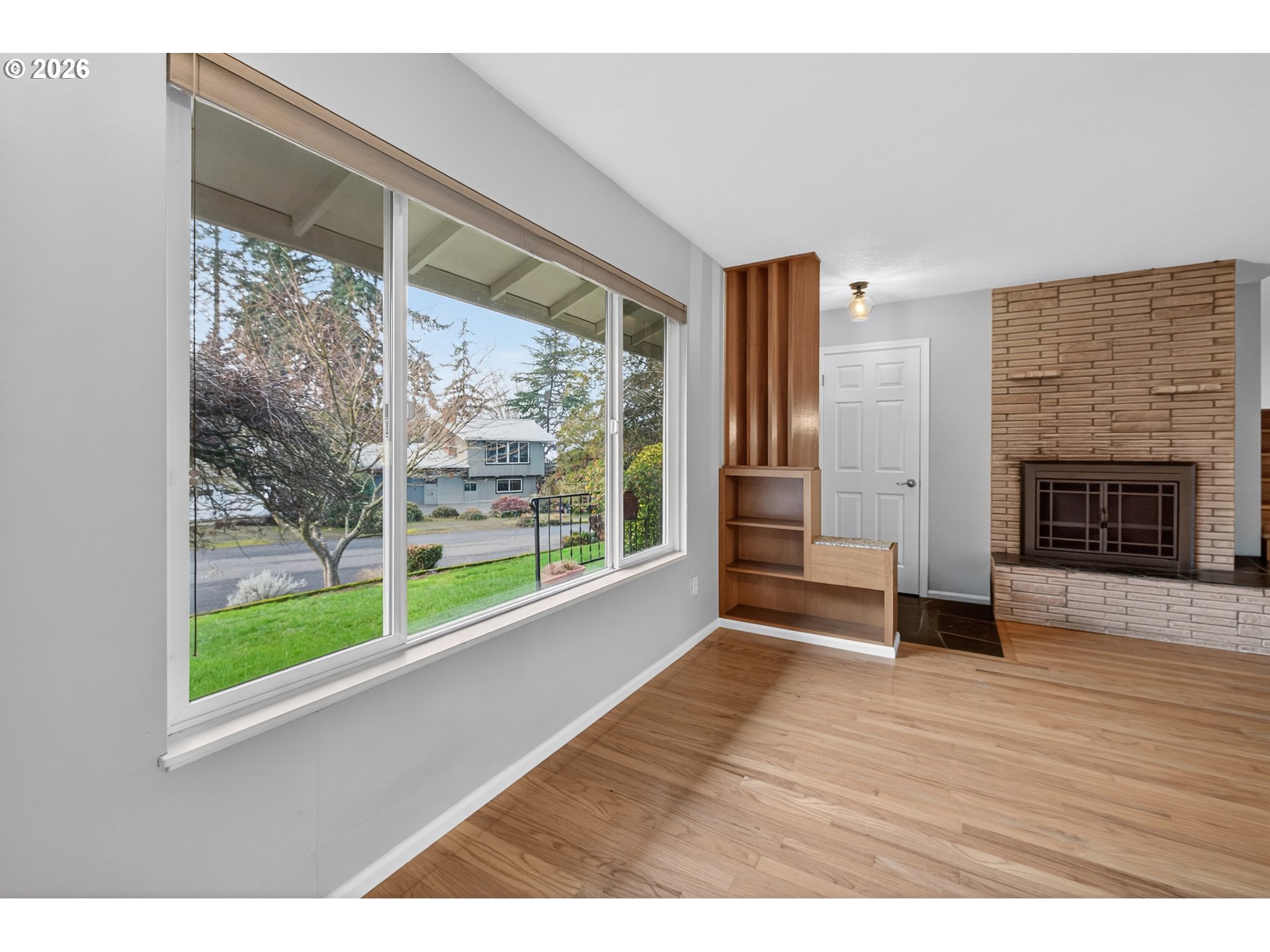 7450 Southwest 101st Avenue Beaverton, OR 97008 - Photo 6 of 37 a view of an empty room with wooden floor and a window