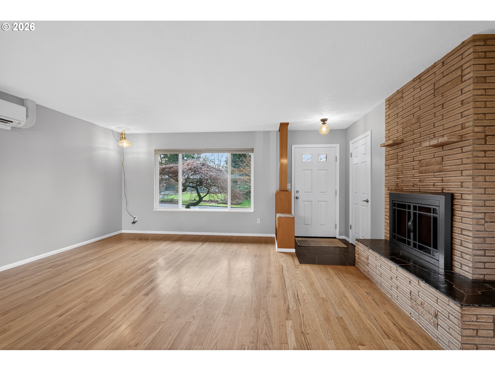 7450 Southwest 101st Avenue Beaverton, OR 97008 - Photo 9 of 37 a view of an empty room with a window and wooden floor