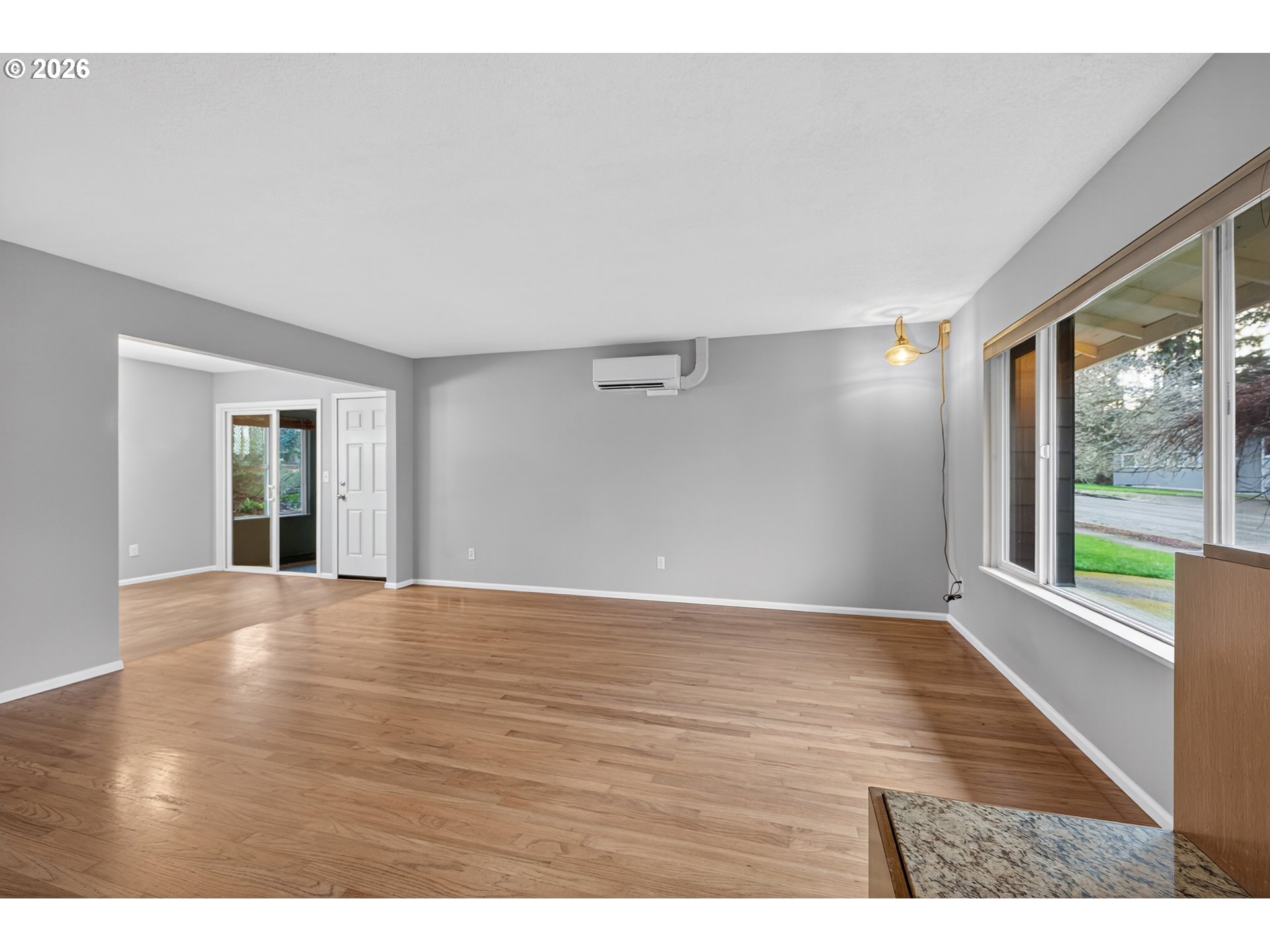 7450 Southwest 101st Avenue Beaverton, OR 97008 - Photo 10 of 37 a view of an empty room with wooden floor and a window