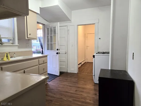 a kitchen with a refrigerator and a sink