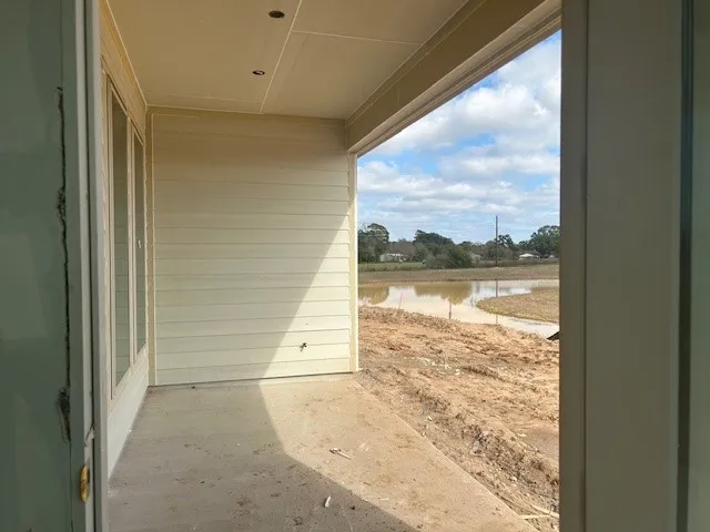 a view of a hallway with wooden shelves