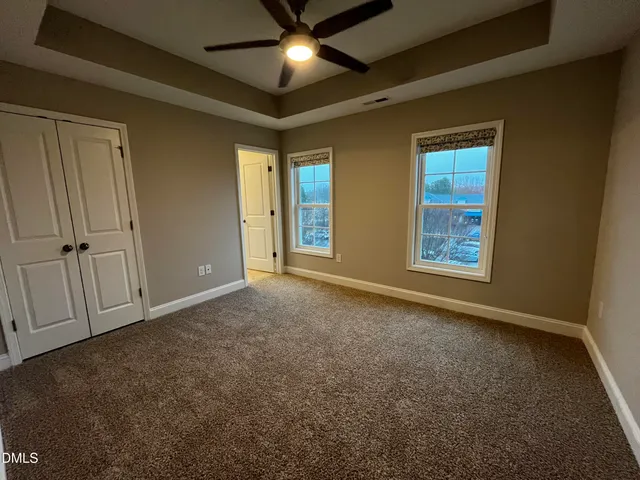 an empty room with windows and closet