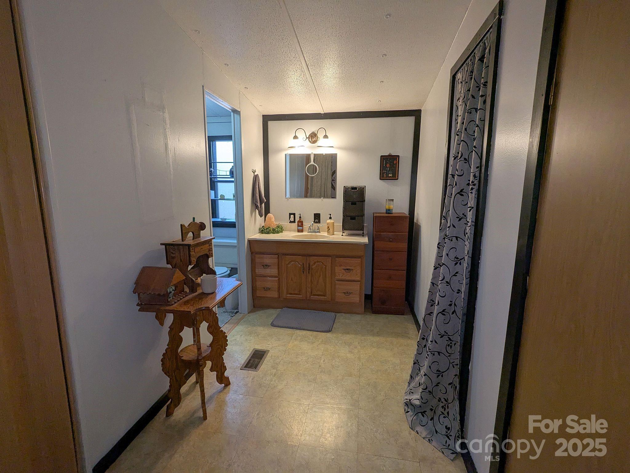 104 Little River Road Fort Mill, SC 29707 - Photo 11 of 21 a view of a hallway and a livingroom with furniture