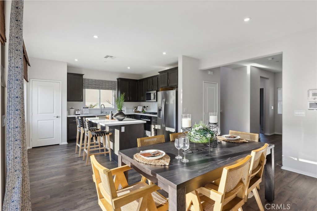 49459 Meadowlark Place Indio, CA 92201 - Photo 11 of 33 a view of a dining room with furniture and wooden floor