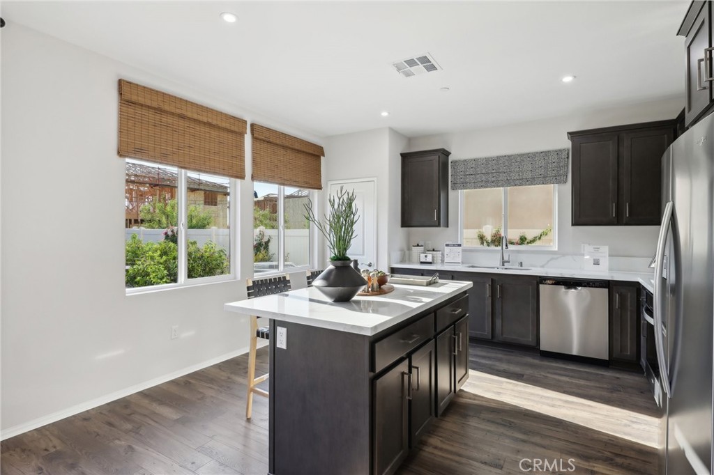 49459 Meadowlark Place Indio, CA 92201 - Photo 15 of 33 a kitchen with kitchen island granite countertop a sink a counter top space and stainless steel appliances