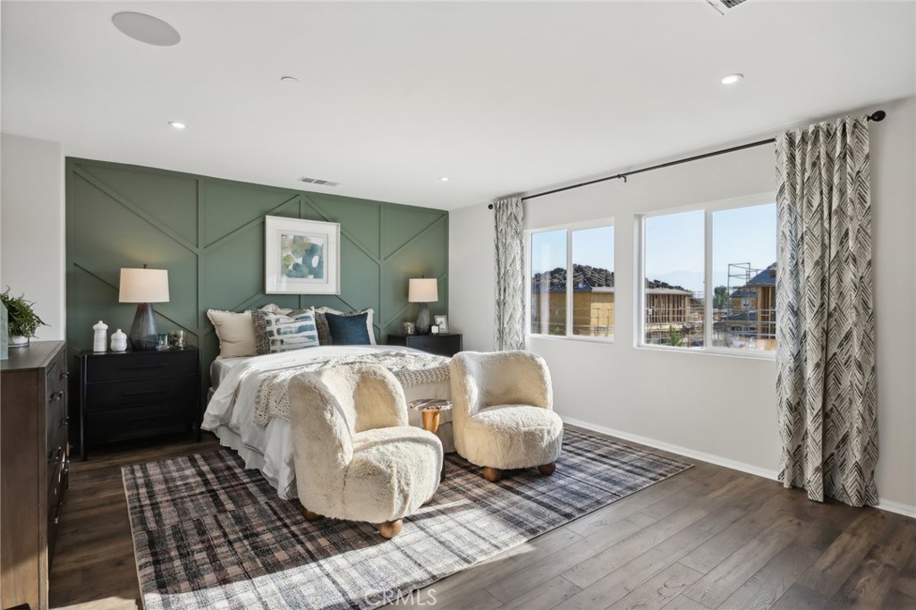 49459 Meadowlark Place Indio, CA 92201 - Photo 24 of 33 a spacious bedroom with a bed and wooden floor