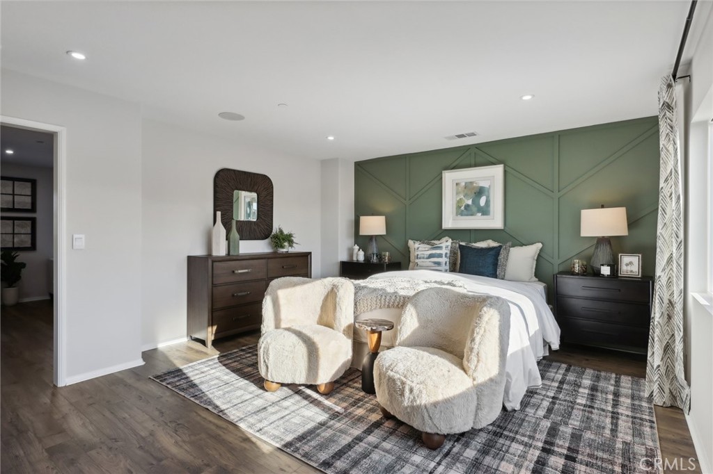 49459 Meadowlark Place Indio, CA 92201 - Photo 27 of 33 a spacious bedroom with a bed and wooden floor