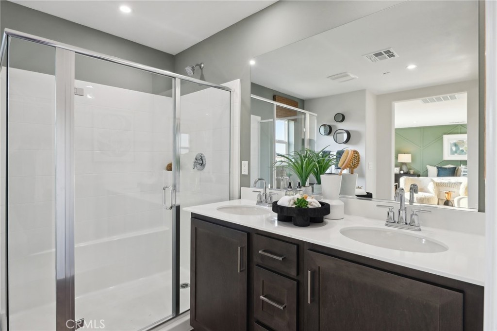 49459 Meadowlark Place Indio, CA 92201 - Photo 29 of 33 a bathroom with a double vanity sink mirror and shower
