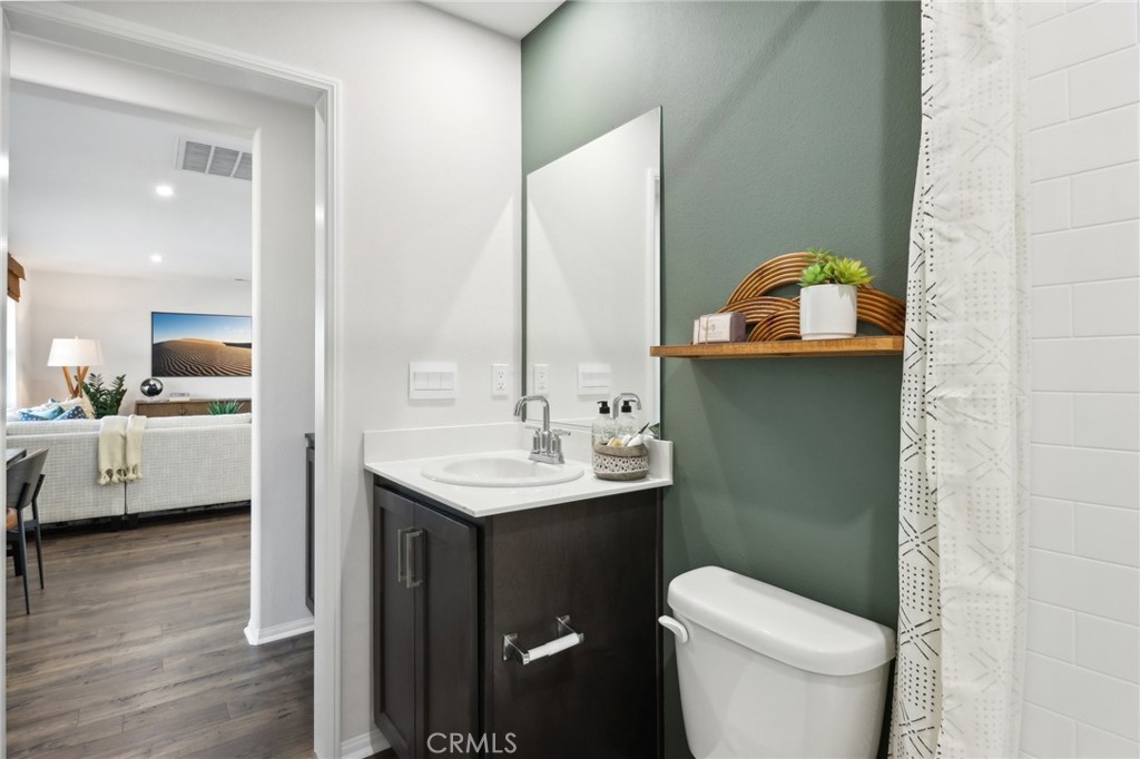49459 Meadowlark Place Indio, CA 92201 - Photo 31 of 33 a bathroom with a toilet sink and mirror