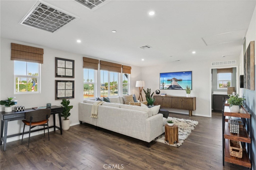 49459 Meadowlark Place Indio, CA 92201 - Photo 6 of 33 a living room with furniture wooden floor and a flat screen tv