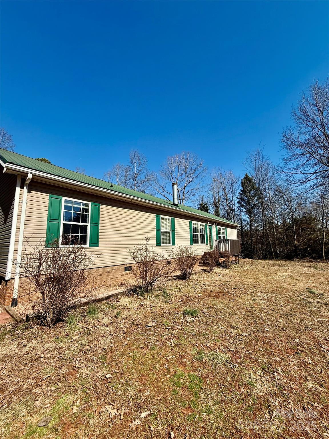 191 Ashford Drive Olin, NC 28660 - Photo 2 of 48 a front view of a house with a garden