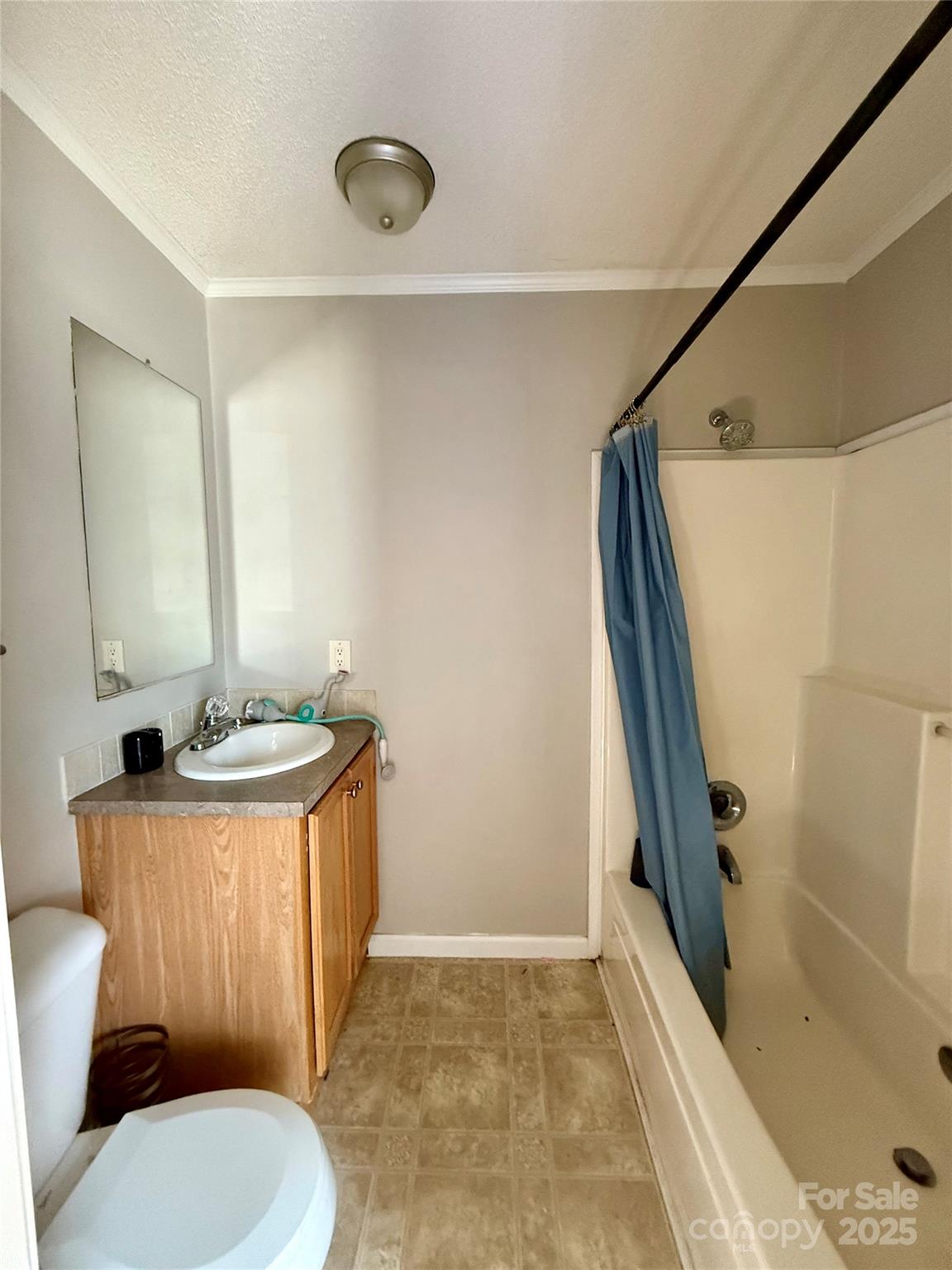 191 Ashford Drive Olin, NC 28660 - Photo 30 of 48 a bathroom with a sink a toilet a mirror and shower