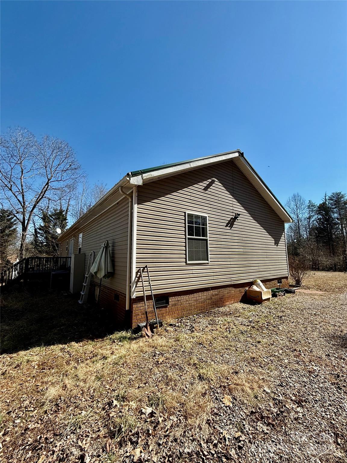 191 Ashford Drive Olin, NC 28660 - Photo 33 of 48 a backyard of a house with large trees