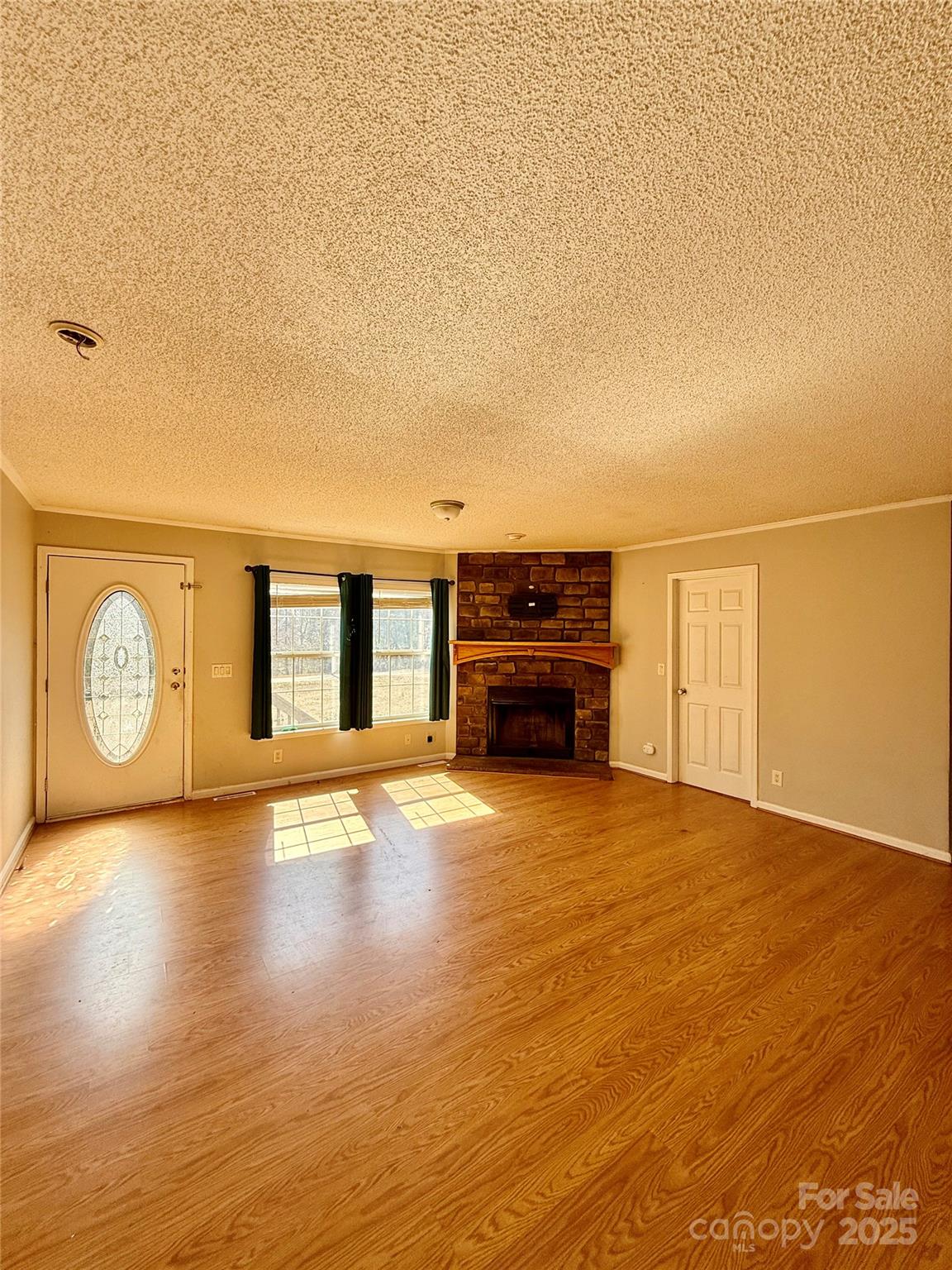 191 Ashford Drive Olin, NC 28660 - Photo 6 of 48 a view of a livingroom with furniture wooden floor and a ceiling fan