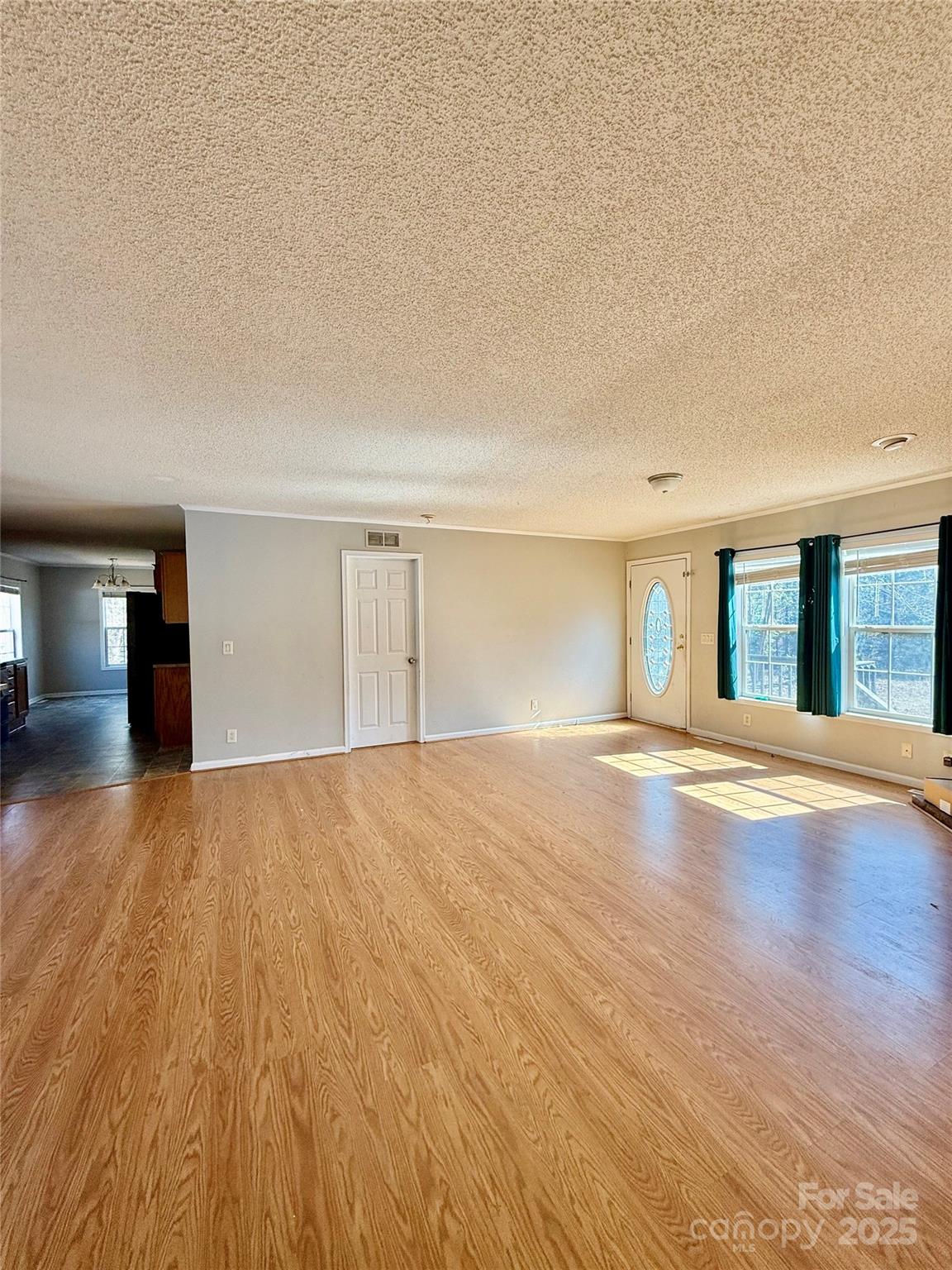 191 Ashford Drive Olin, NC 28660 - Photo 7 of 48 a view of empty room with wooden floor and fan