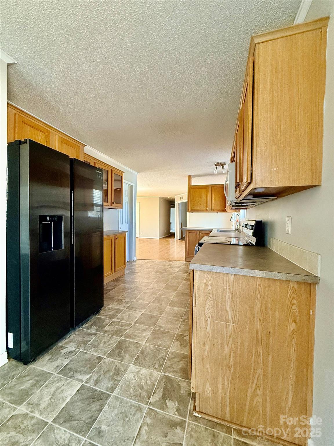 191 Ashford Drive Olin, NC 28660 - Photo 10 of 48 a kitchen with stainless steel appliances granite countertop a refrigerator and a stove