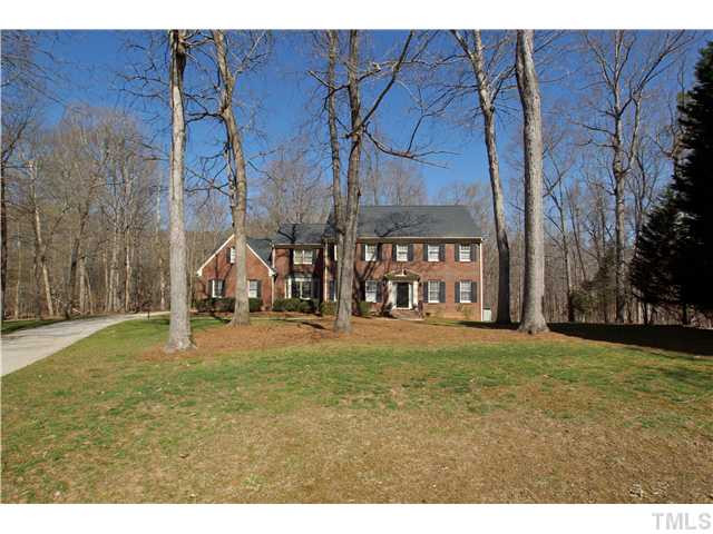a house with a yard and a wooden fence