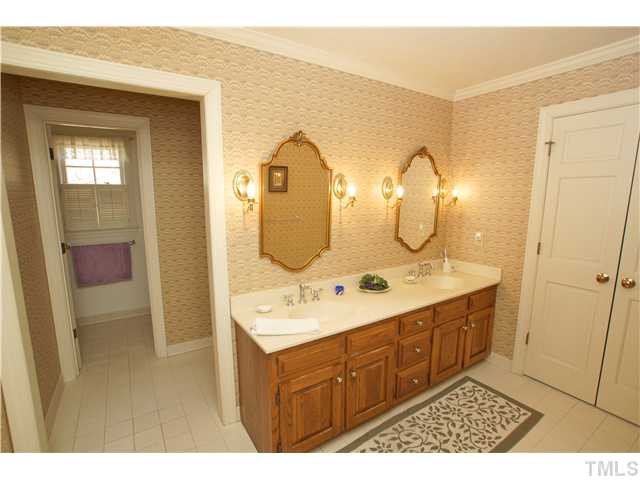 7309 Mevan Court Raleigh, NC 27613 - Photo 13 of 22 a bathroom with a double vanity sink and a mirror