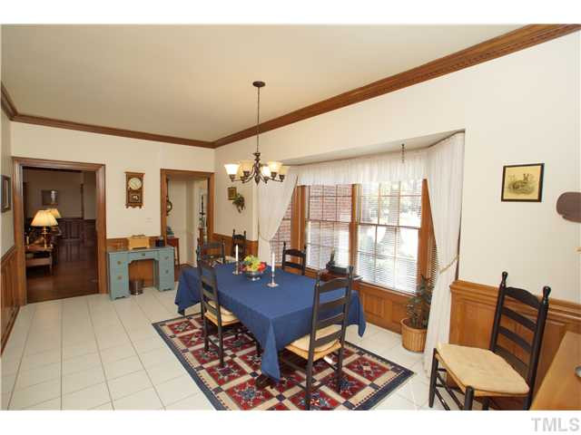 7309 Mevan Court Raleigh, NC 27613 - Photo 15 of 22 a living room with furniture a rug and a chandelier