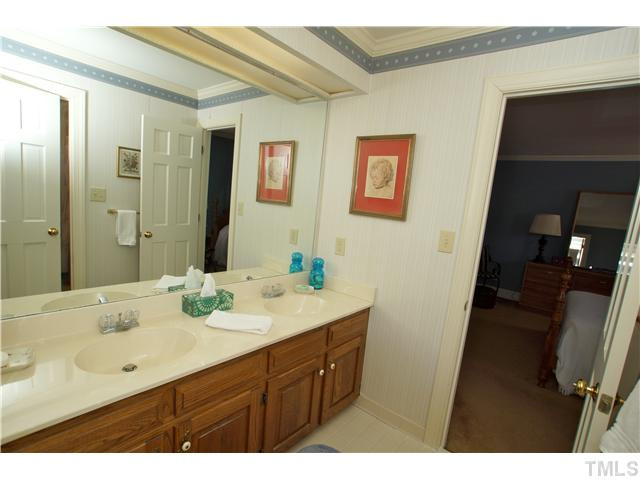 7309 Mevan Court Raleigh, NC 27613 - Photo 17 of 22 a bathroom with a sink mirror and double