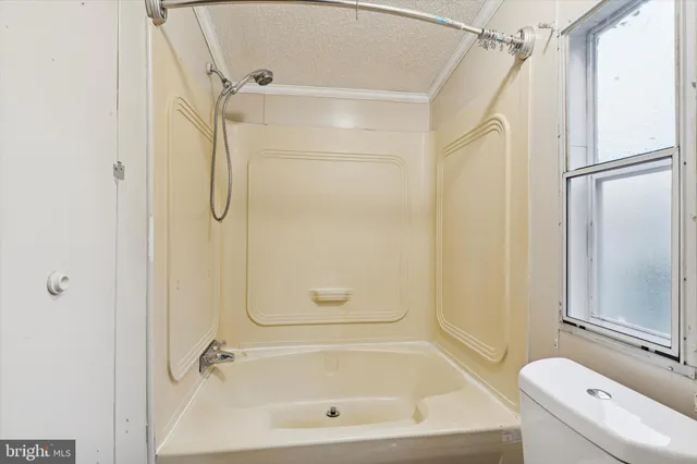a bathroom with a bath tub with a shower