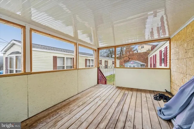 a view of a room with wooden floor