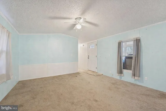 a view of an empty room with a fan