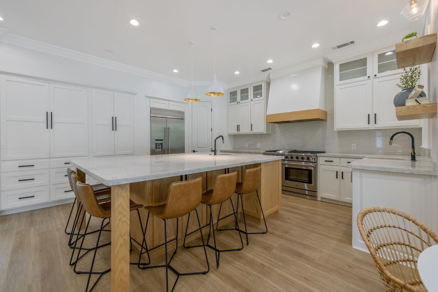 1548 North Rova Street Visalia, CA 93291 - Photo 5 of 9 a kitchen with granite countertop white cabinets and appliances