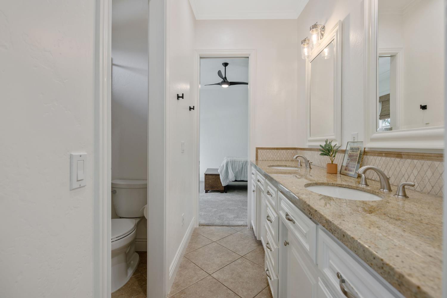 1548 North Rova Street Visalia, CA 93291 - Photo 6 of 9 a bathroom with a granite countertop sink and a mirror