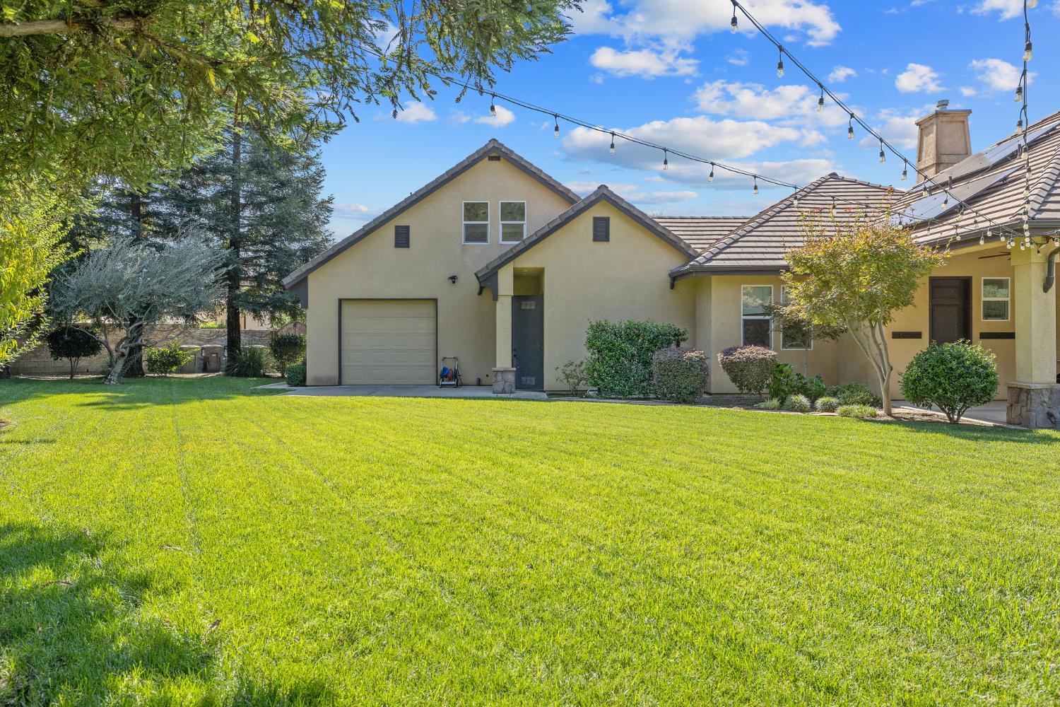 1548 North Rova Street Visalia, CA 93291 - Photo 7 of 9 a view of a house with pool and a yard