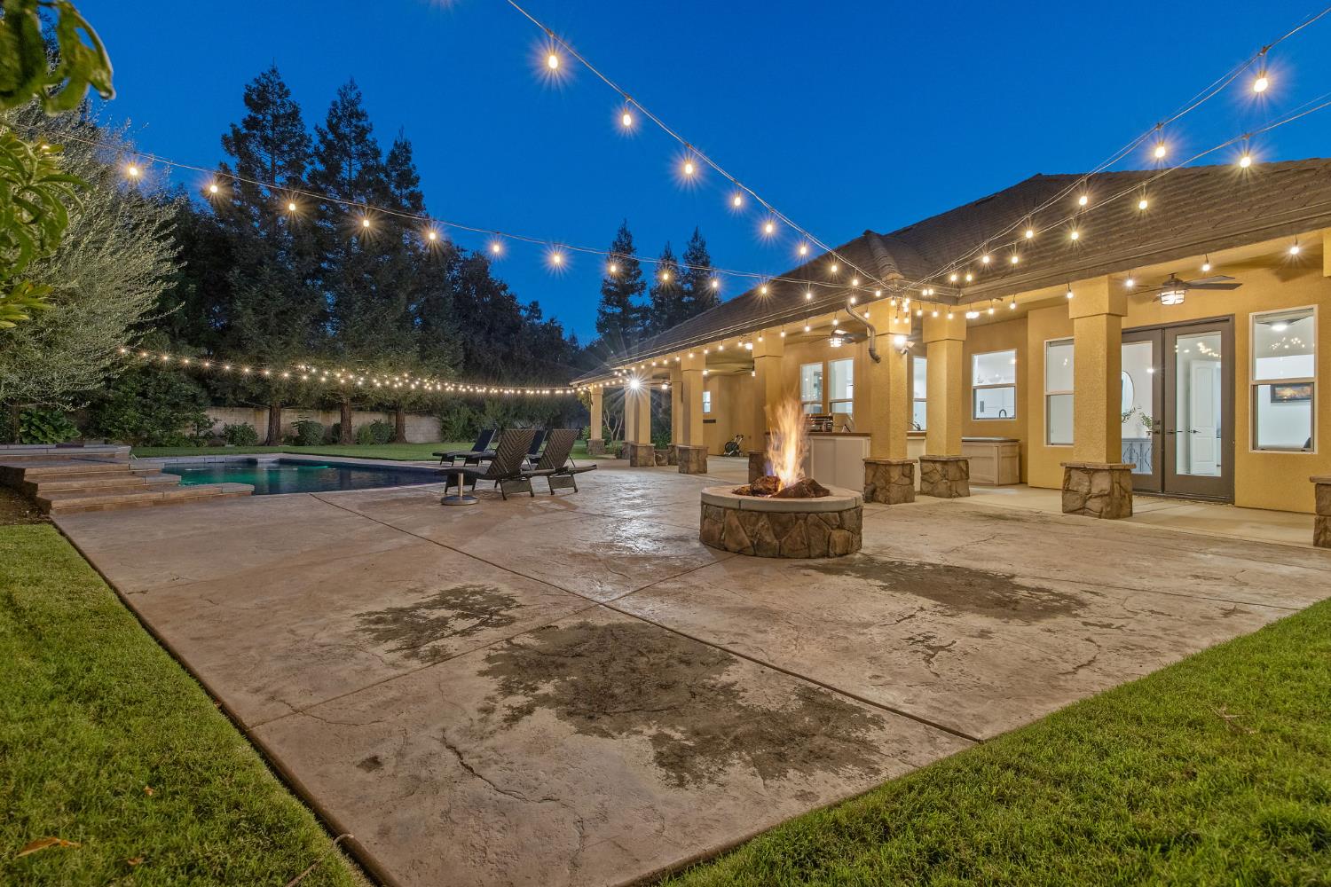 1548 North Rova Street Visalia, CA 93291 - Photo 8 of 9 a view of a swimming pool with lawn chairs under an umbrella