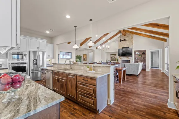 a kitchen with kitchen island granite countertop a large center island and a sink