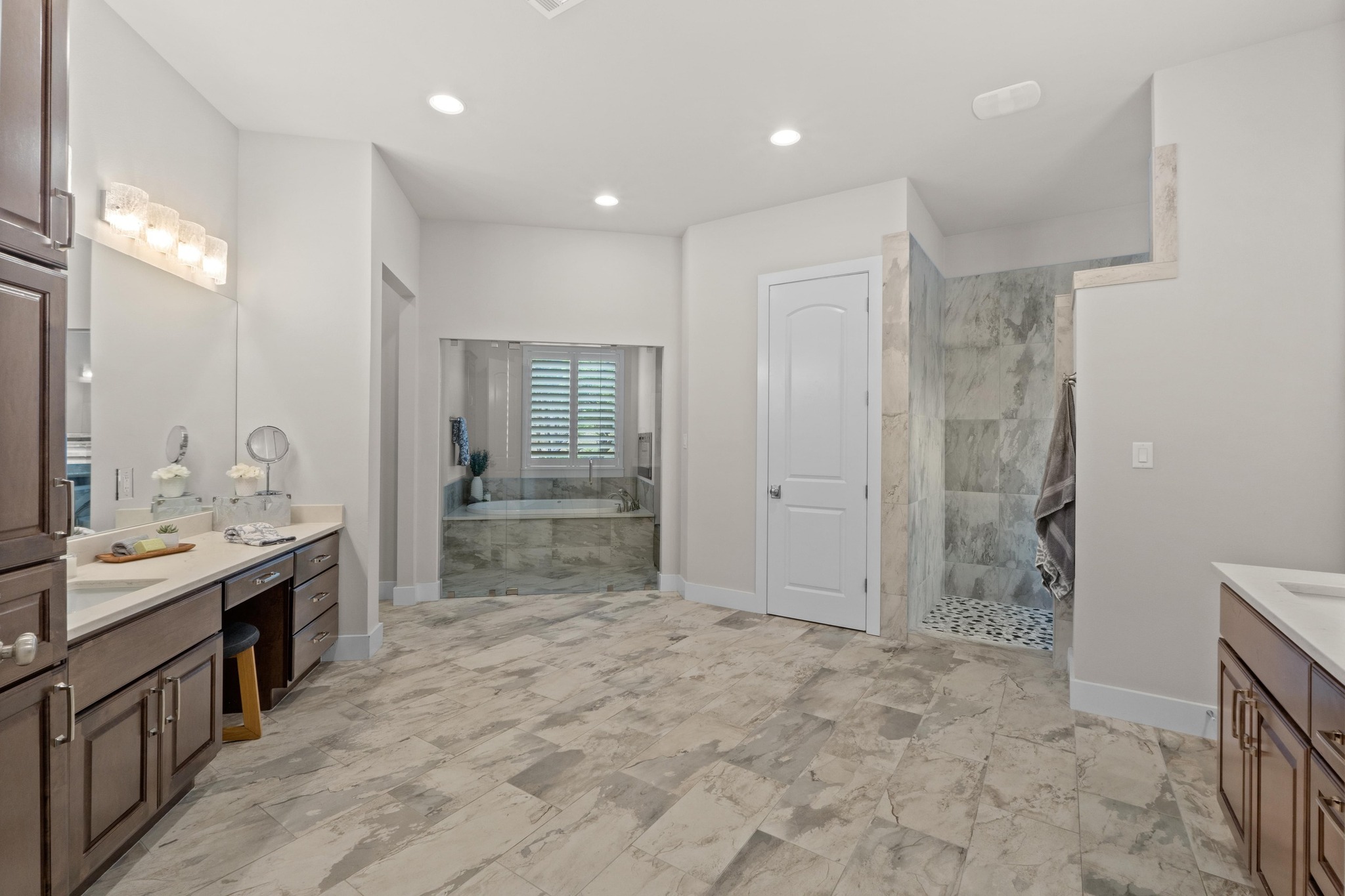18817 Hidden Ridge Place Jonestown, TX 78645 - Photo 16 of 40 a bathroom with mirror sink and glass door